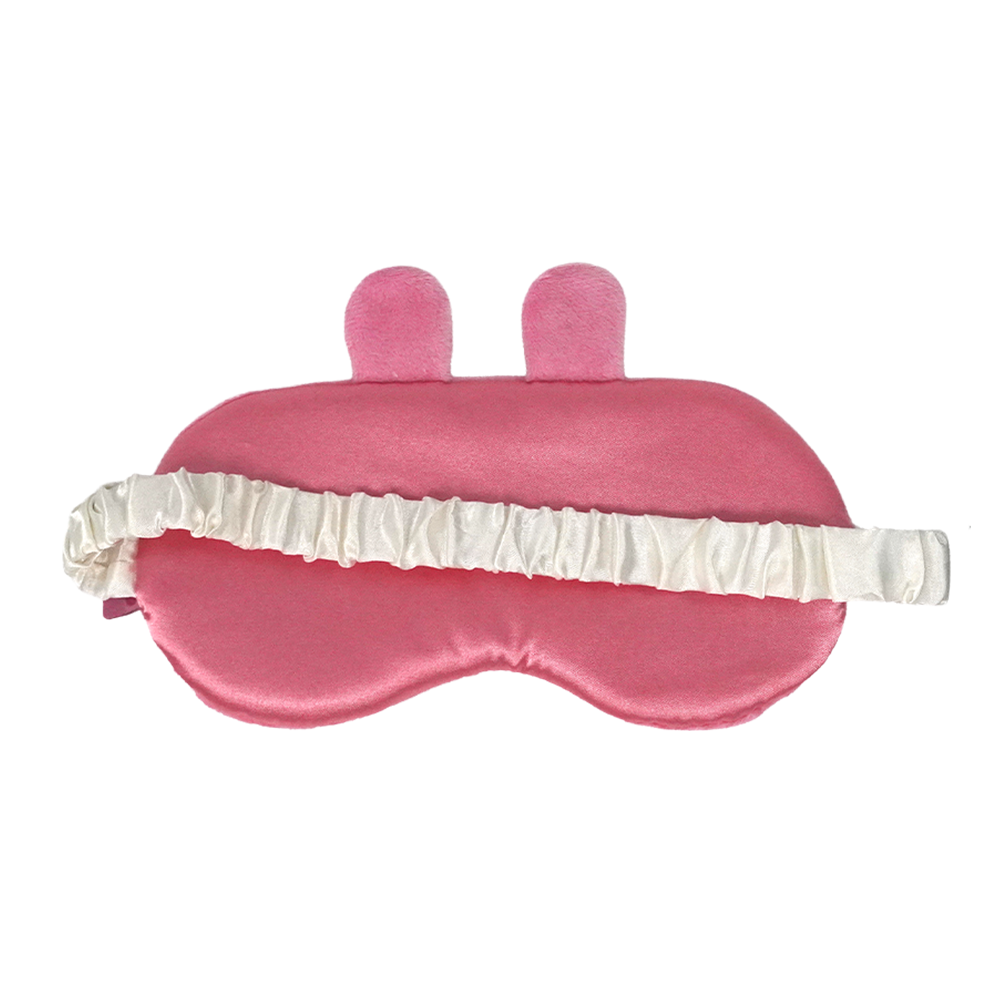 A pink satin sleep mask with two small upright bunny ears on top and a white ruffled elastic strap, shown on a plain white background.
