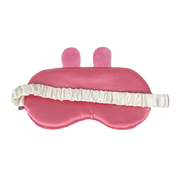 A pink satin sleep mask with two small upright bunny ears on top and a white ruffled elastic strap, shown on a plain white background.