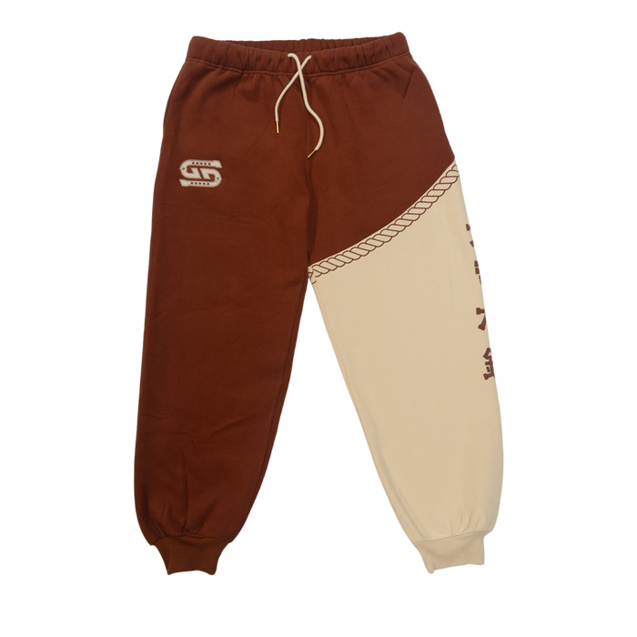 Rust-colored fabric with a white embroidered "G" logo featuring star details on the sweatpants.