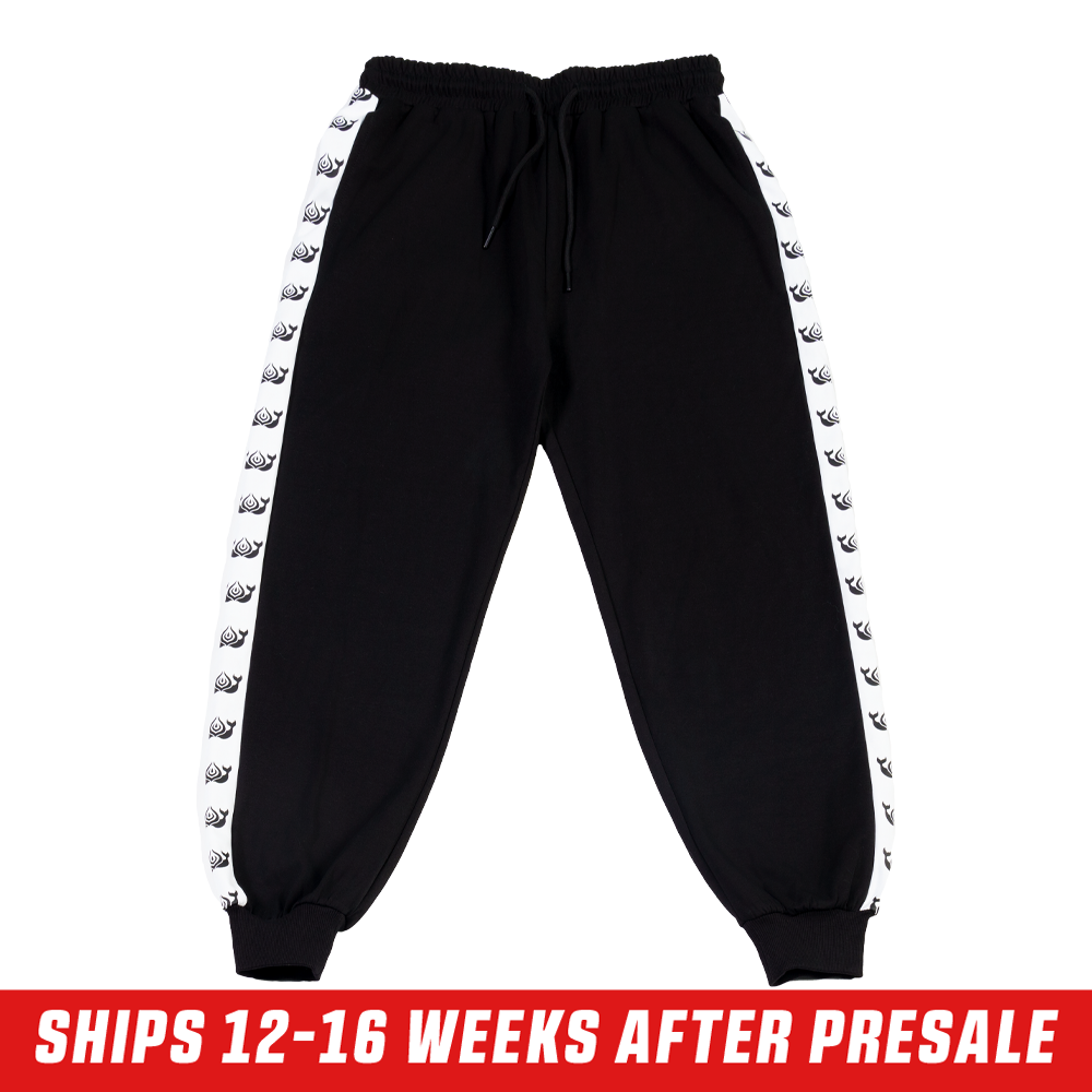 Black track pants with white side stripes featuring repeating killer whale silhouettes and a back pocket.